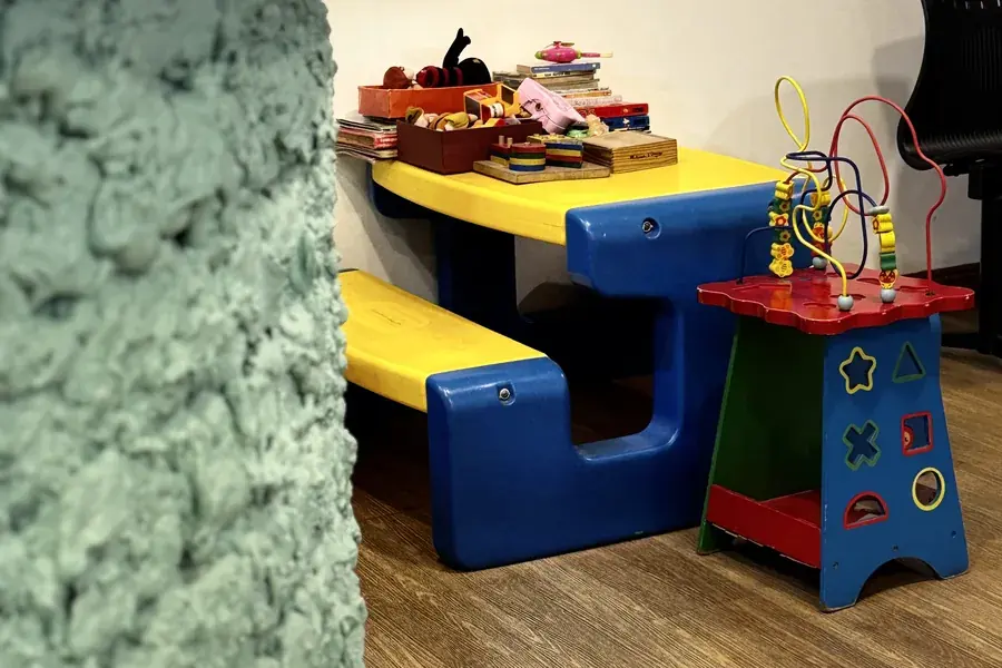A children's play table and activity toys in the waiting area at FTS Chin Dental